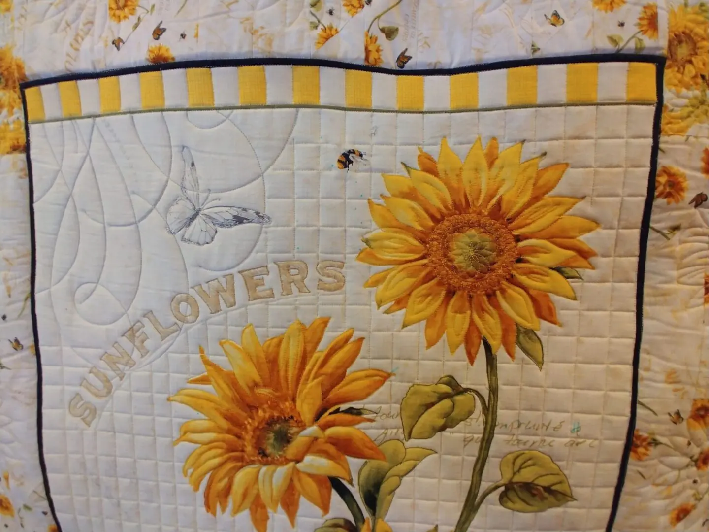 A close up of the sunflowers on this quilt