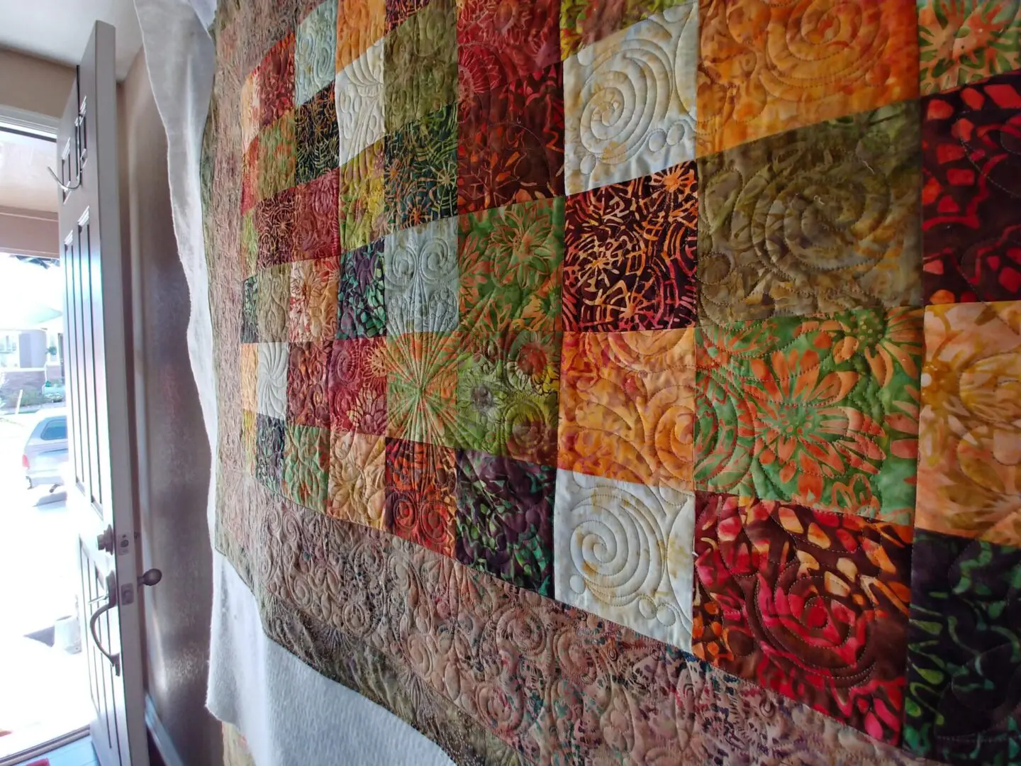 A quilt with many different colors of fabric.