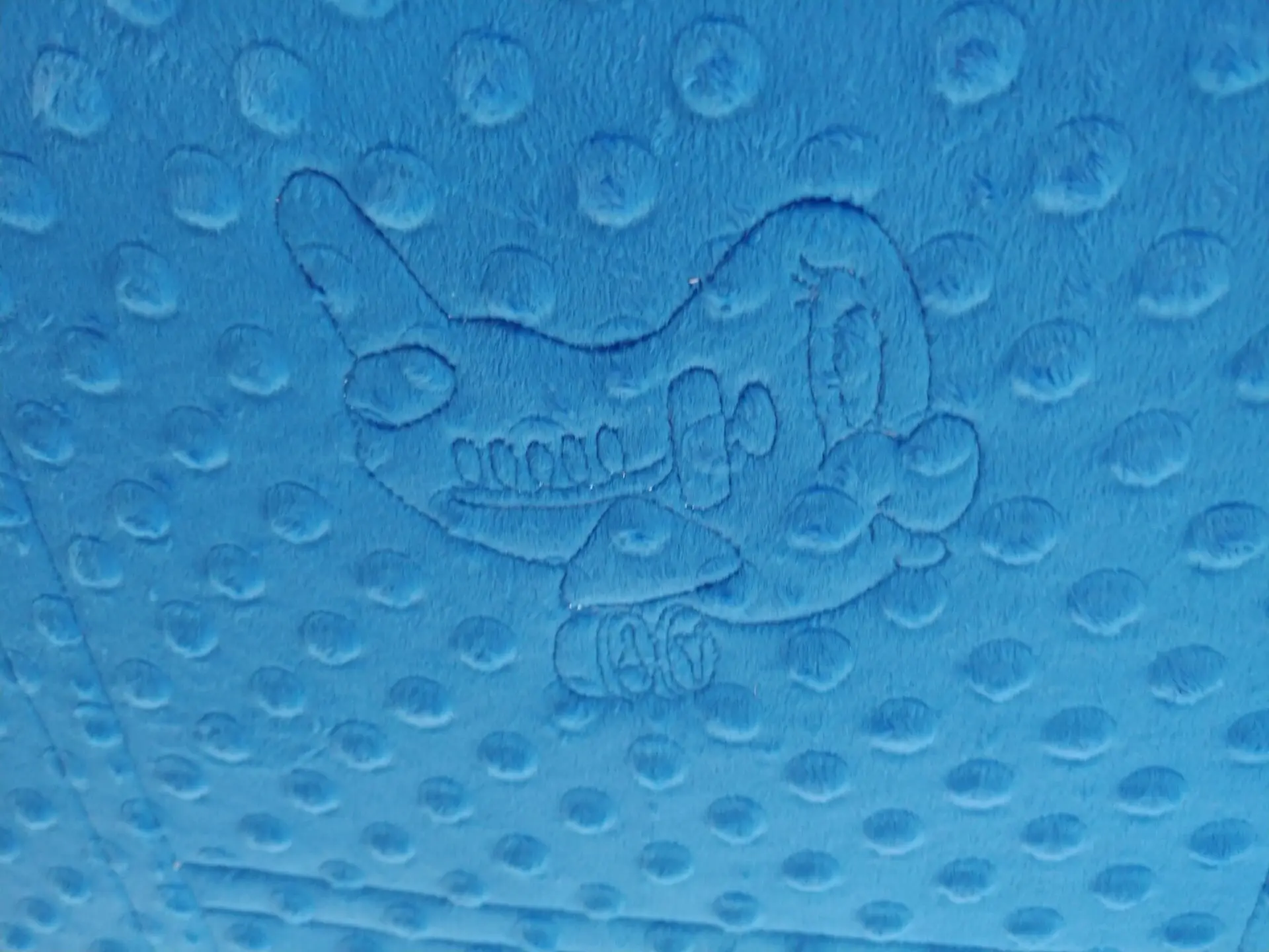 A close up of the air plane on a blue blanket