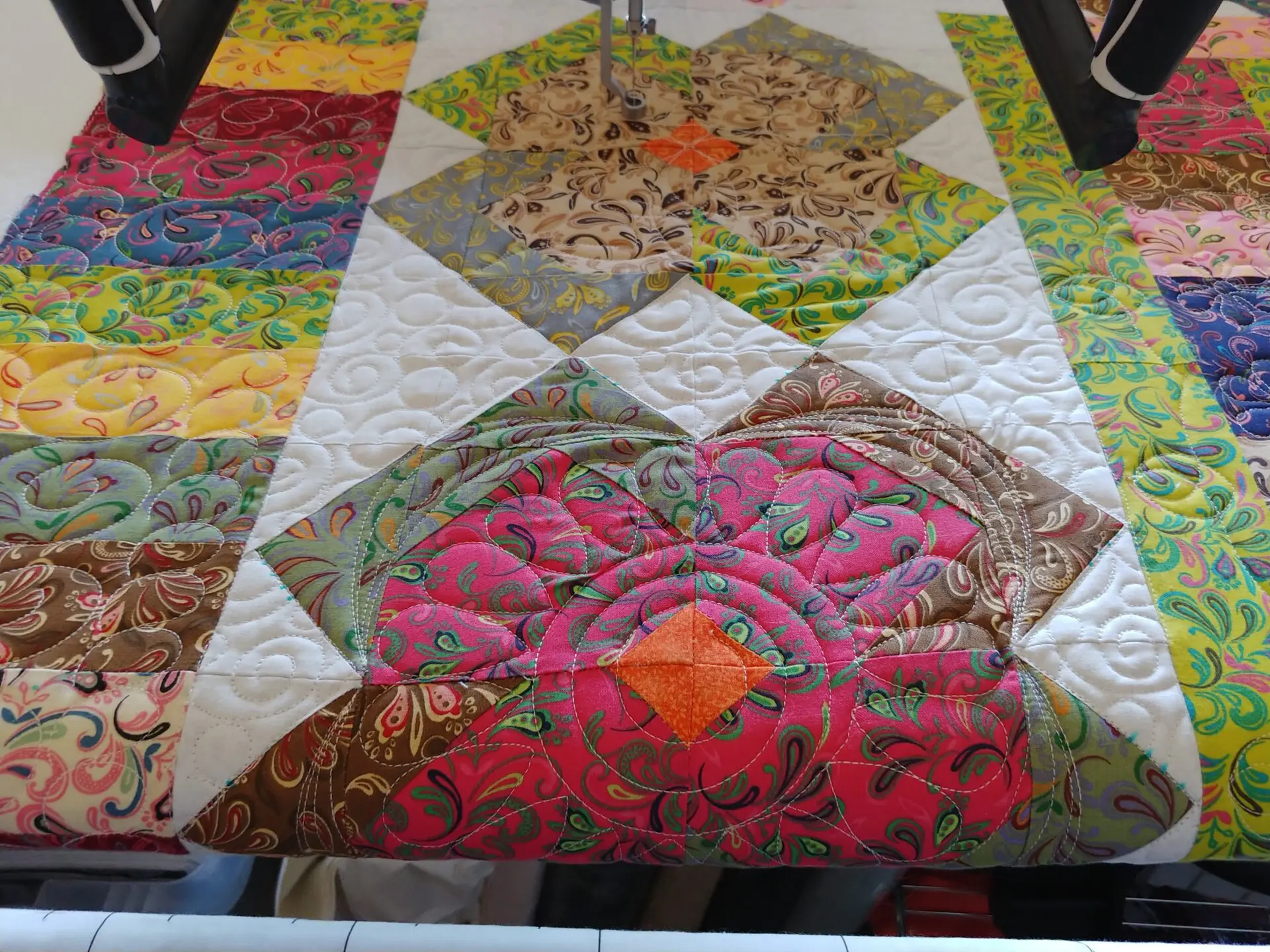 A quilt with many different colors and designs