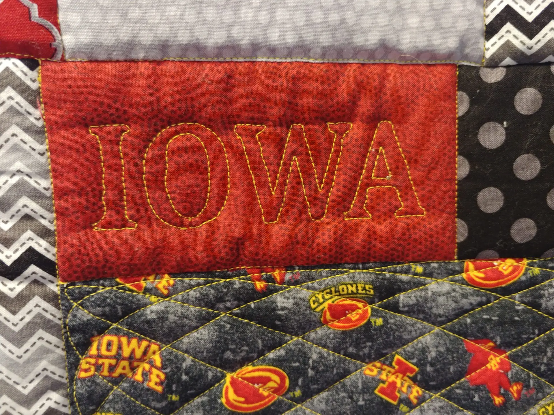 A close up of the iowa state logo on a quilt.