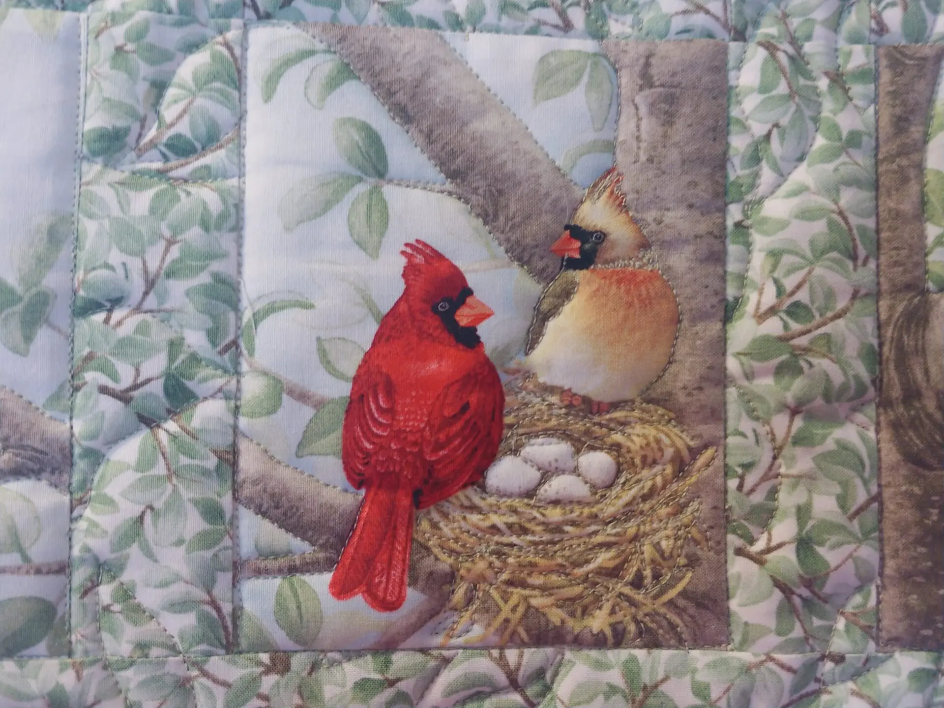 A painting of two birds sitting on top of eggs.