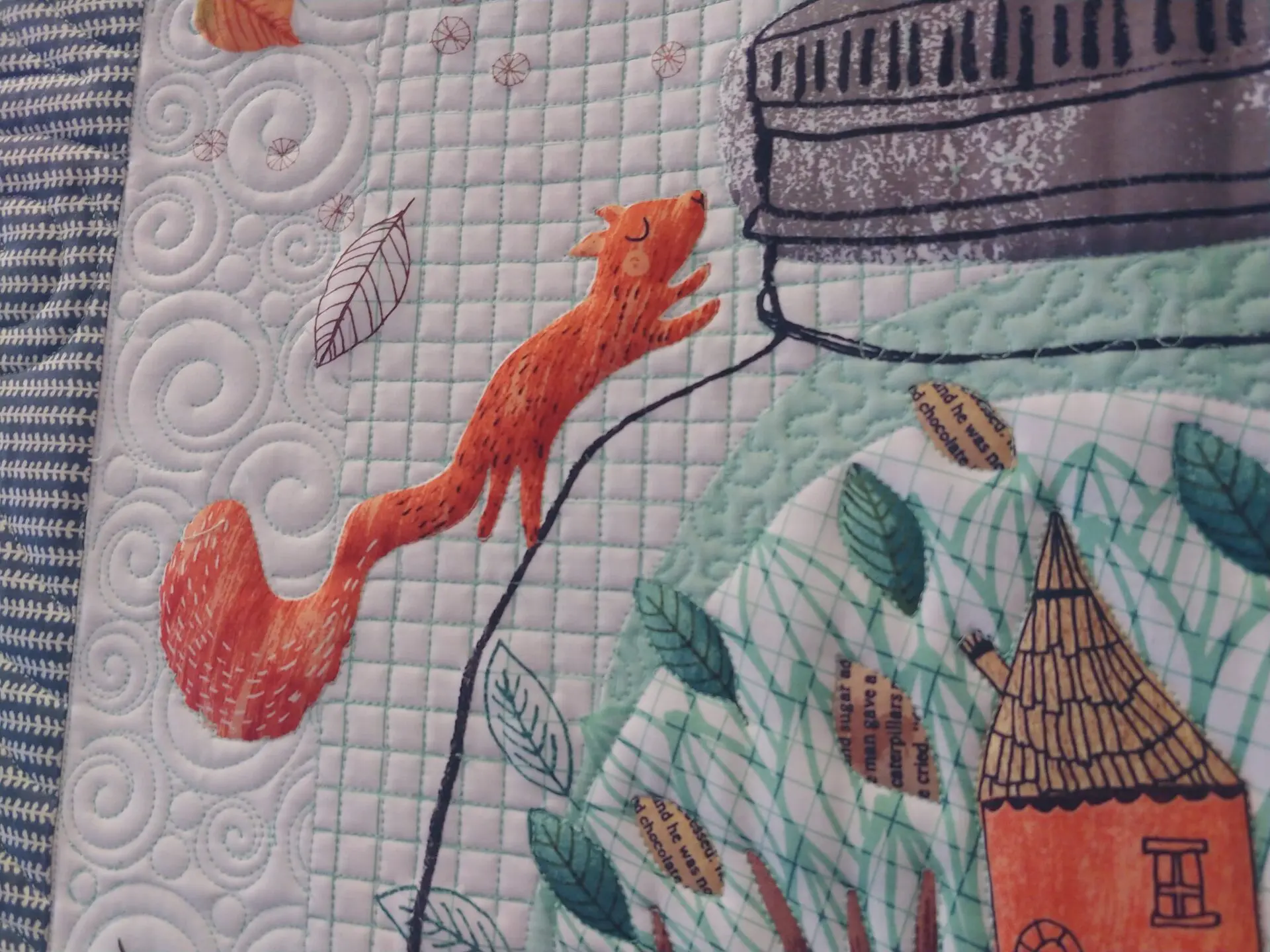 A close up of the fabric with an orange squirrel on it