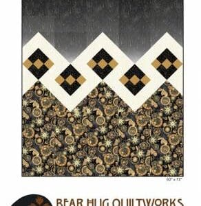 A quilt with black, white and gold designs.