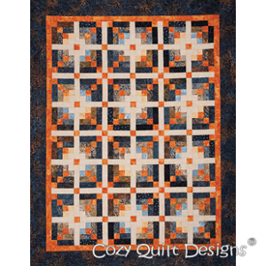 A quilt with orange and white squares on it.