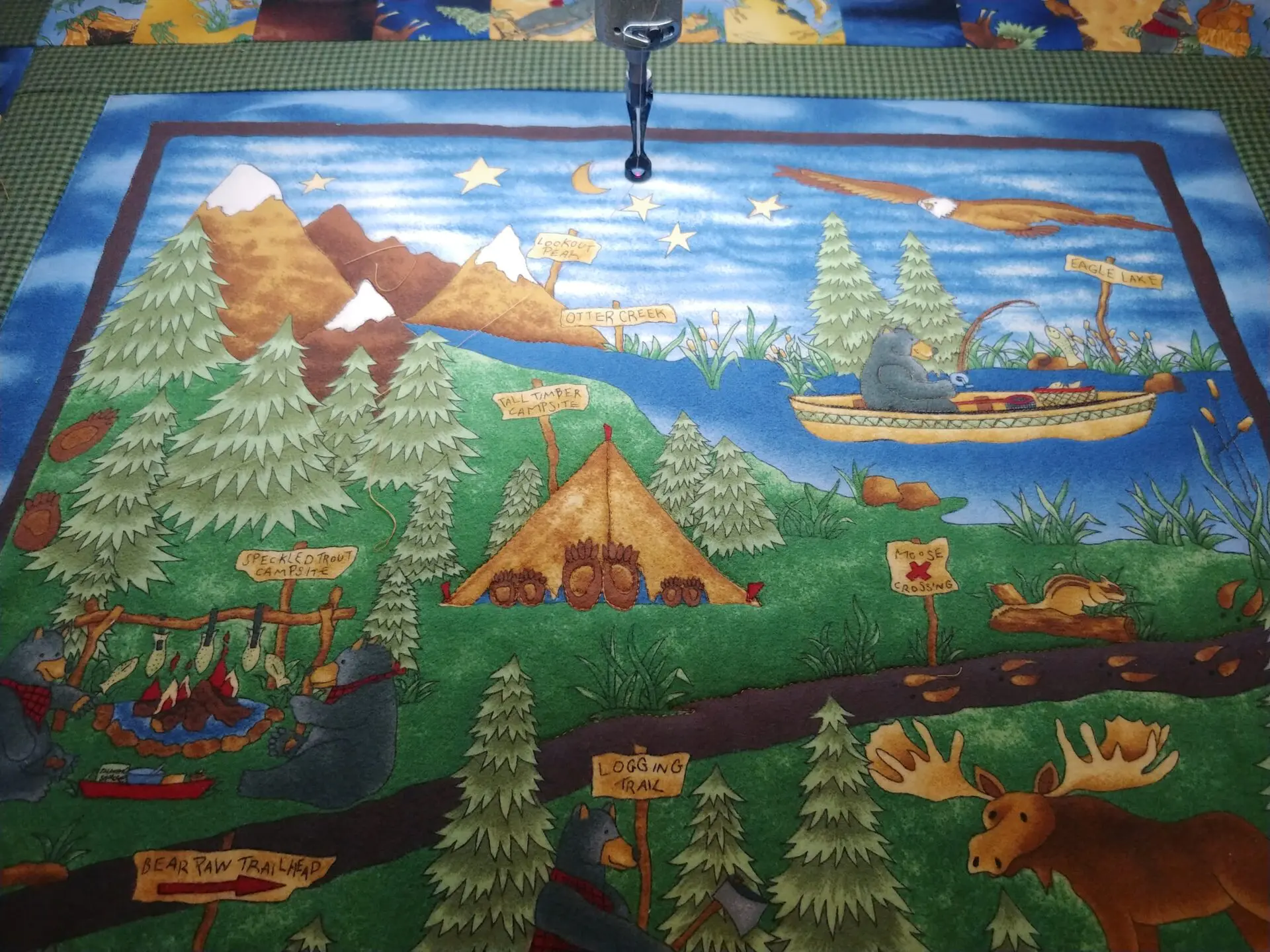 A mural of camping and trees painted on the wall.