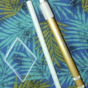 A straw and a plastic container on a blue background