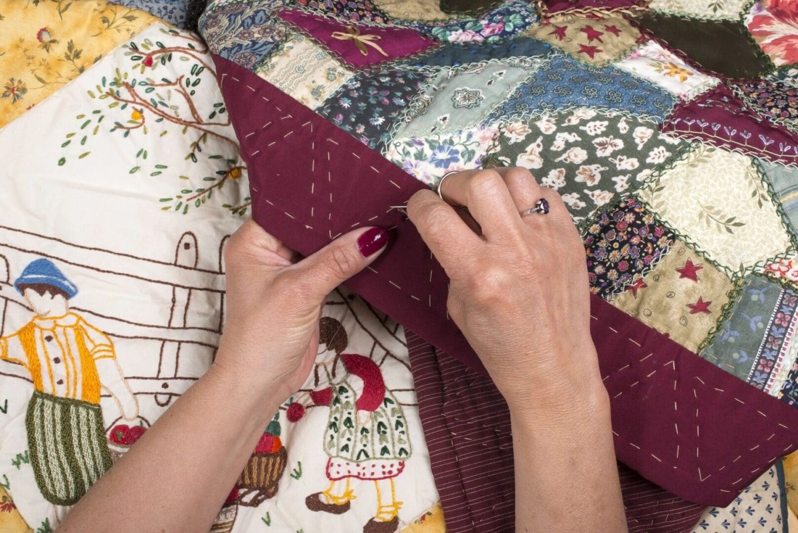 A person is sewing on the quilt