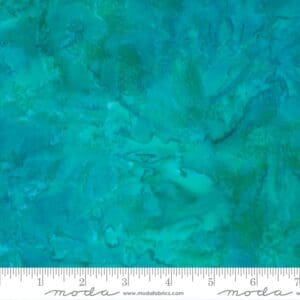 Close-up of teal and turquoise textured fabric with a subtle mottled pattern.