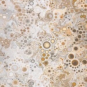 Close-up of a textured surface with circular patterns in beige and brown tones.