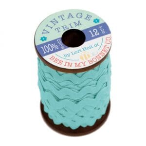 A spool of blue vintage-style fabric labels.