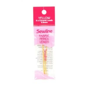 Yellow sewing thread spools in pink packaging.