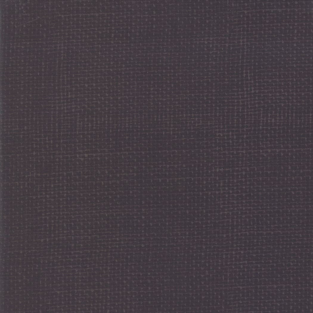 Dark textured fabric with grid pattern.