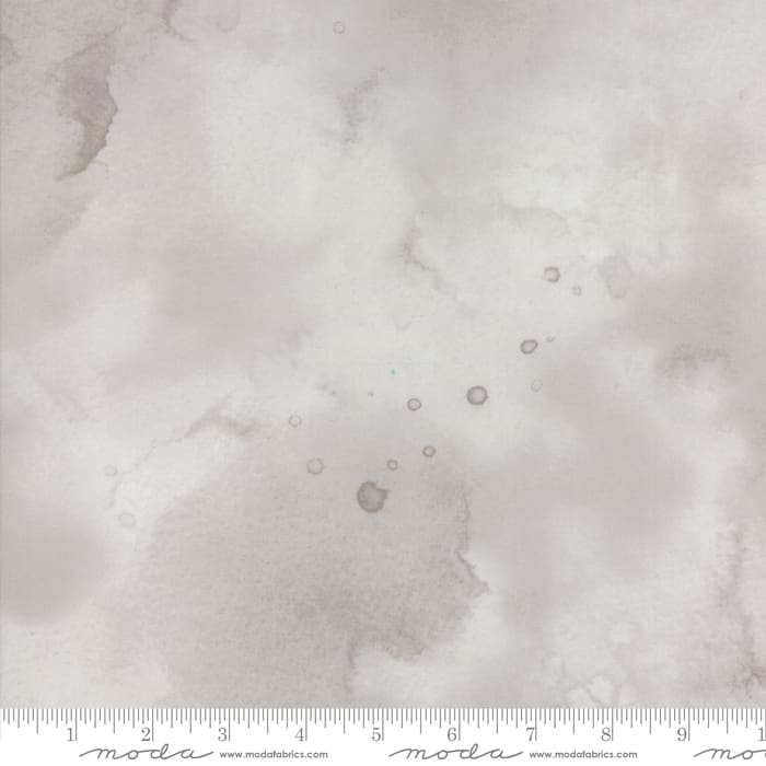 Light gray textured fabric with ruler border.