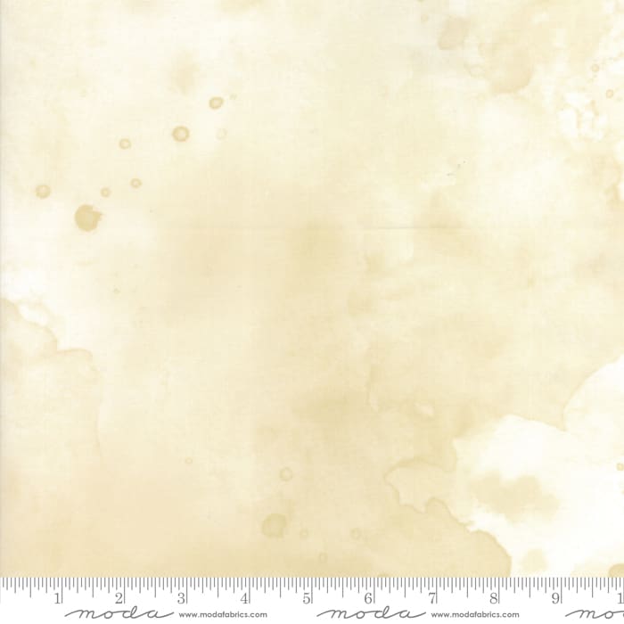 Beige fabric with subtle texture and ruler.