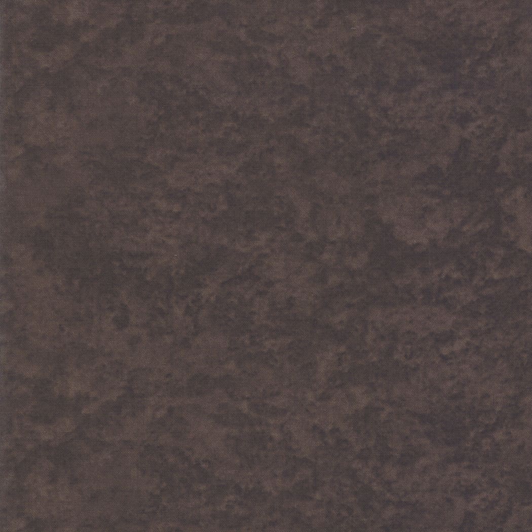 Dark textured stone-like surface pattern.