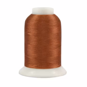 Brown thread spool on white background.