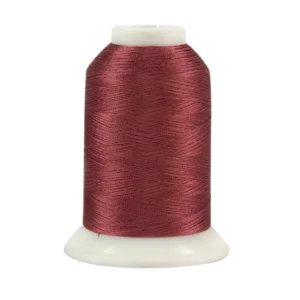 Burgundy thread spool on white background.