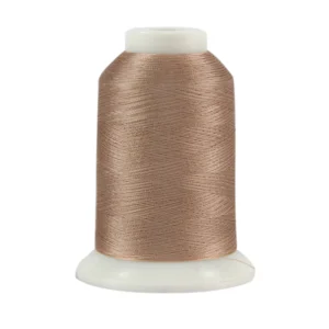 Spool of brown sewing thread on white.